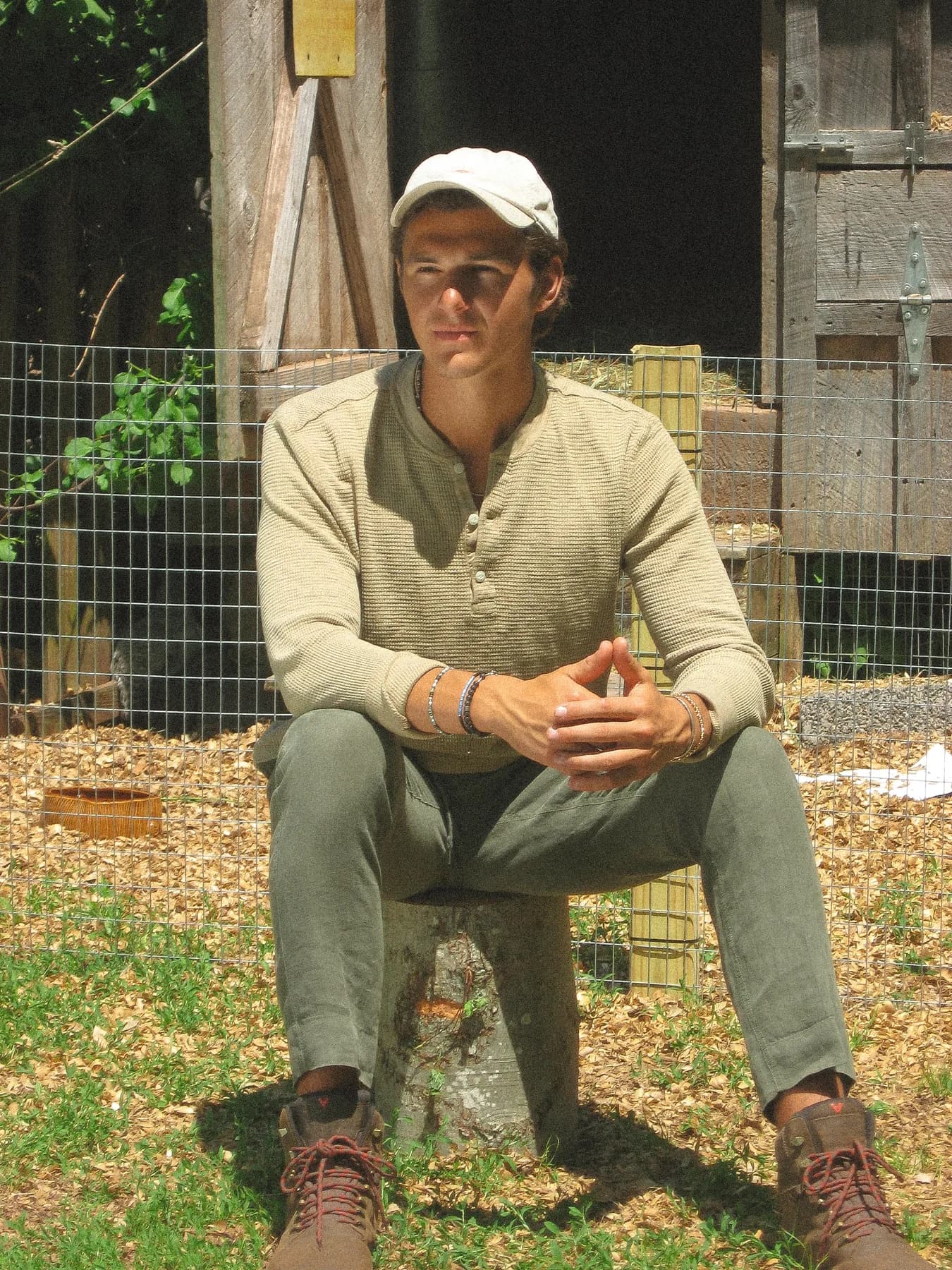 Jake sitting outside a weathered wooden building